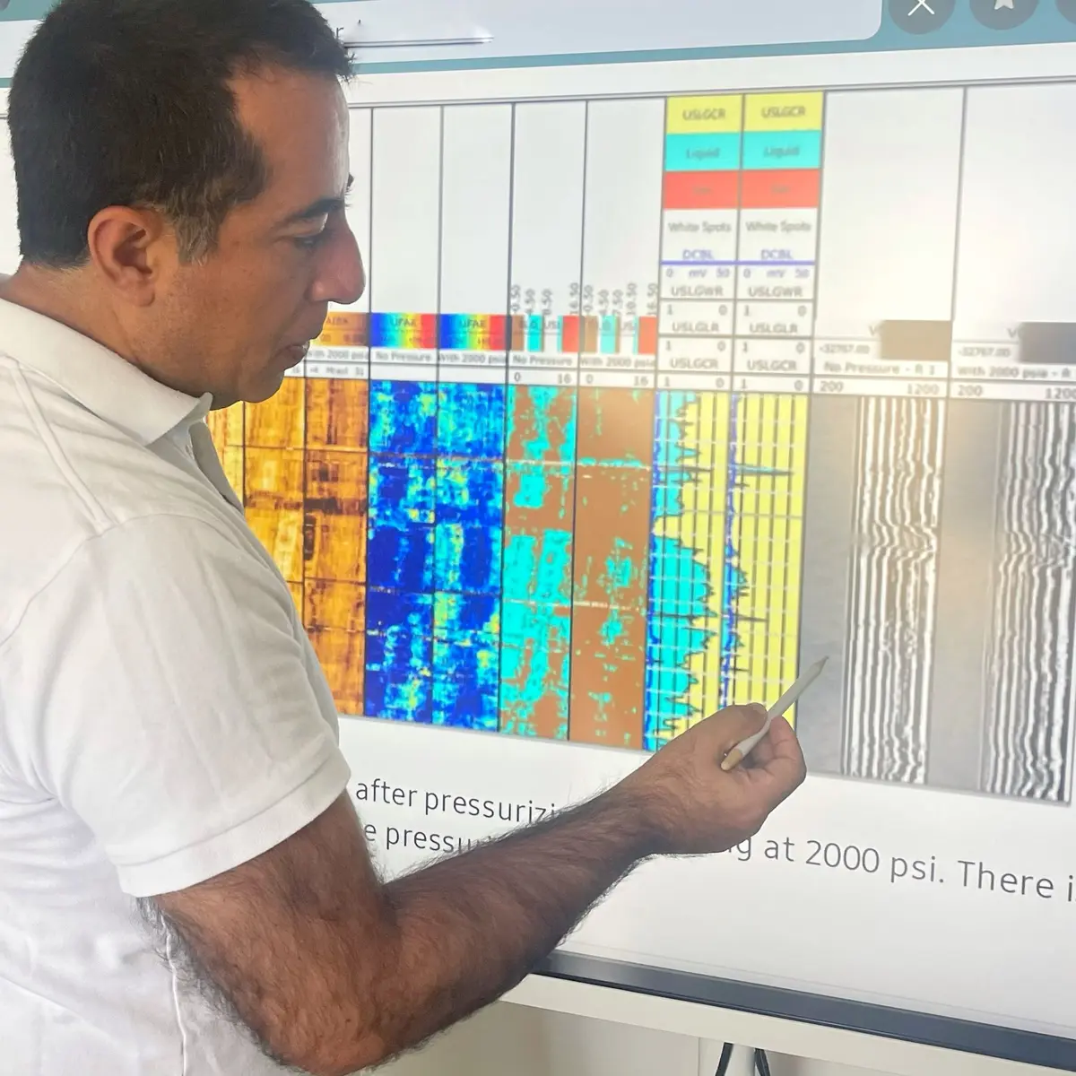 Diego Florez reviewing cement evaluation logs